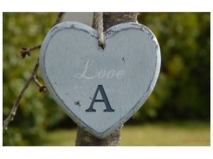 Your lover's name on the heart hanging from wood