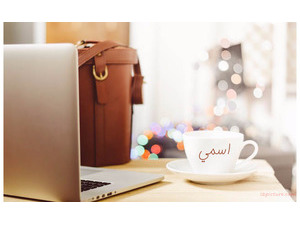 Your name on the cup and laptop next to him